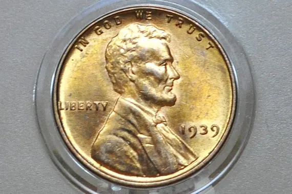 1939 wheat penny grading strip showing four coins in condition tiers from Good (heavily worn) to Mint State (uncirculated with red luster)